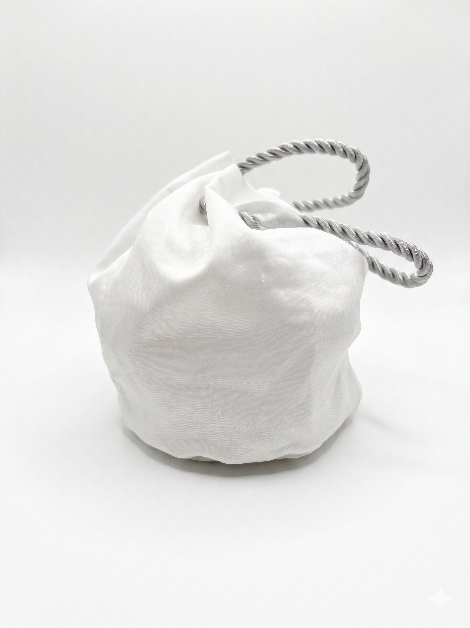 White drawstring bag with a rope handle on a white background